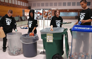 Kids sorting trash in the cafeteria.